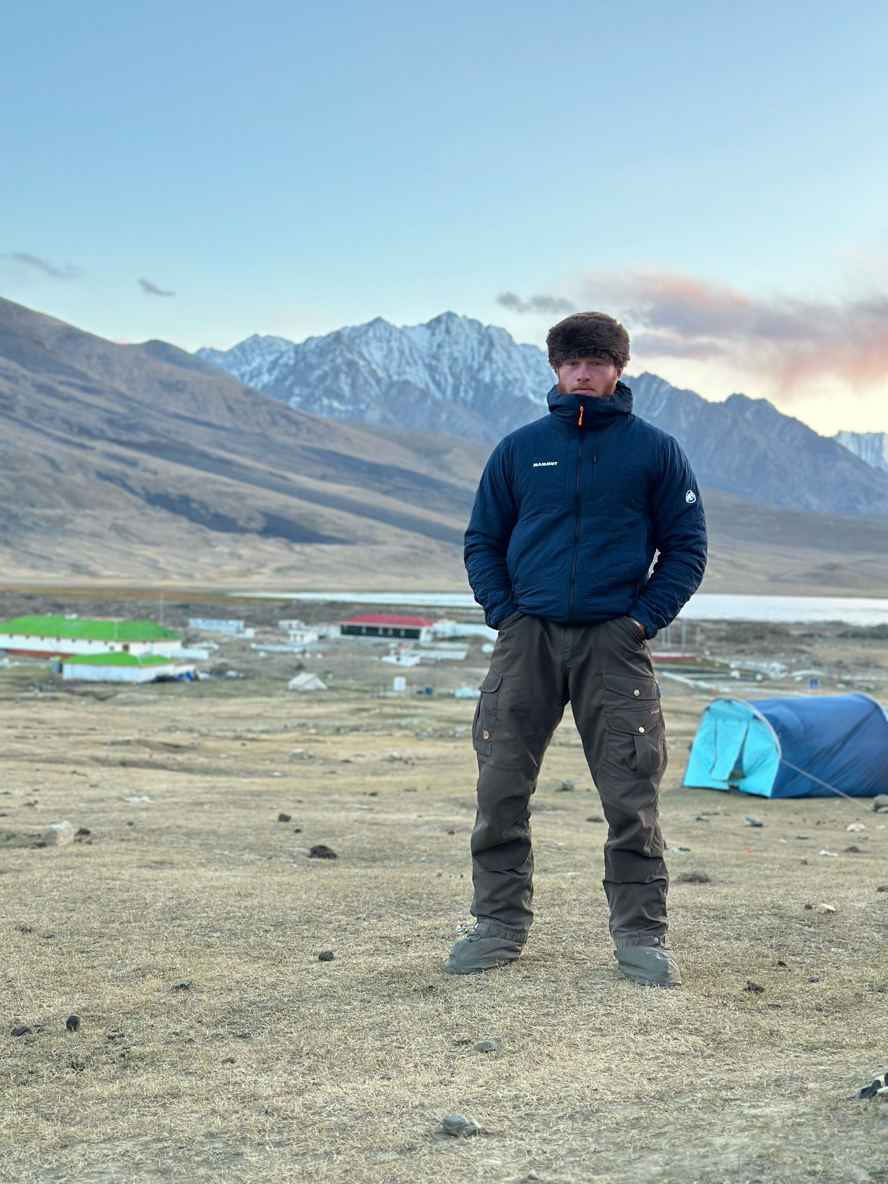 A Frontiersman at high camp, mountains behind